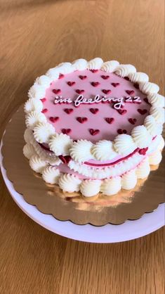 a heart - shaped cake on a plate with the words in loving you written on it