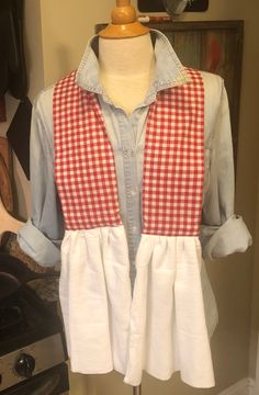 a mannequin wearing a red and white checkered shirt with ruffles