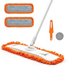 an orange mop and two cleaning sponges on a white background