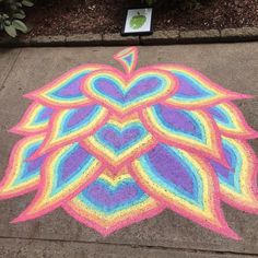 a colorful drawing on the sidewalk in front of a building