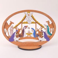 a wooden nativity scene with the birth of jesus and baby jesus in manger