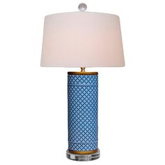 a blue and white table lamp with a light shade on the top, sitting in front of a white background