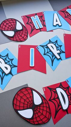 spiderman themed birthday party decorations and cut outs on a table with the numbers 1 - 10