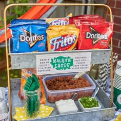 an outdoor stand with food and drinks on it