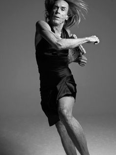 an old man is playing tennis on a white background with his racket in the air