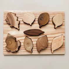 a wooden wall hanging with different shapes and sizes