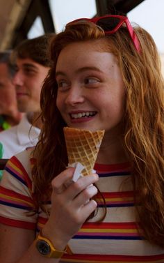 a young woman eating an ice cream cone