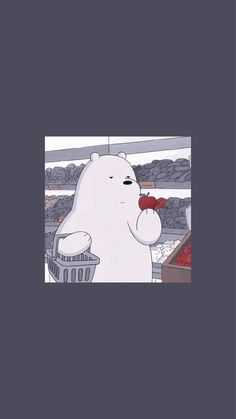 a polar bear holding a red object in it's mouth