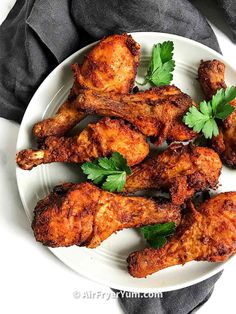 chicken wings with parsley on a white plate