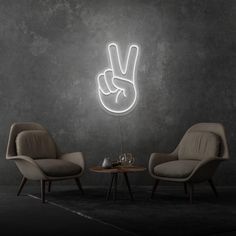 two chairs and a table in front of a wall with a peace sign on it