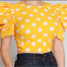 "Polka Hot" Is A Haltered Polka Dot Top, That Features An Exaggerated Shoulder That Ties In Either Front Or Back. Yellow Cotton Party Top, Yellow Cotton Top For Party, Polka Dot Fitted Cropped Top, Fitted Cropped Polka Dot Top, Chic Yellow Short Sleeve Crop Top, Chic Yellow Cropped Blouse, Fitted Polka Dot Top For Spring, Cropped Workout Top, Metallic Crop Top