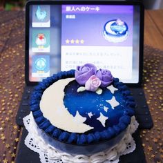 a cake sitting on top of a laptop computer