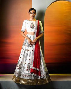 Hand-Embroidered Indo Western White Lehenga with Block Print, Paired Perfectly with a Red Dupatta - A Stunning Red and White Wedding Lehenga Set.Indulge in timeless allure with our hand-embroidered Indo Western White Lehenga, adorned with intricate block print details. This exquisite ensemble is the epitome of sophistication, presenting a harmonious union of white lehenga choli and a striking red dupatta. The meticulous hand embroidery adds a touch of opulence, making it the ideal choice for weddings. Embrace the eternal charm of this red and white wedding lehenga set, where every detail reflects the grace and beauty of tradition.Fabric details:Blouse - Cotton LinenLehenga - Cotton LinenEmbroidery - Gotta patti, sequin, moti, reshamMaterial Used: Cotton linen Colour: White, Black and Red C Festive White Lehenga With Bandhani Print, White Lehenga With Printed Motifs, White Embroidered Lehenga, Ivory And Red Lehenga, White Lehenga With Embroidered Border, White Wedding Lehenga, White Lehenga Choli, White Lehenga, Red And White Weddings