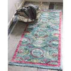 an area rug with various colors and designs on the floor in front of a door