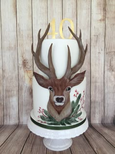 a cake decorated with an image of a deer's head and the number forty