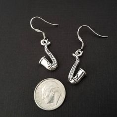 SAXOPHONE EARRINGS - Beautiful silver plated saxophone charm earrings Size of saxophone charm: 22x11mm MATERIAL: Lead free, nickel free, This set makes a perfect gift for any saxophonist, marching band member or music teacher. Music Earrings, Football Bracelet, Hedgehog Gifts, Mothers Bracelet, French Hook Earrings, Music Jewelry, Moms Bracelet, Ball Bracelet, Animal Earrings