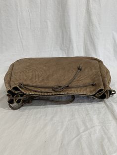 "Measurements are 12\"5 wide, 8\"3 high, 3\" deep with a 40\" shoulder strap. On the interior there is one main compartment with a back zipper pocket, lined in vinyl with a top magnetic closure. Bag is made of tan leather with taupe trim and front patches. Some light scuffs and some marks with no tears or holes and bag can be used crossbody. 100% genuine Carlos Falchi made in USA. I WANT TO STRESS THAT THIS ITEM IS VINTAGE WHICH MEANS IT'S NOT NEW. IF YOU'RE LOOKING FOR A NEW BAG PLEASE DON'T BI Vintage Beige Hobo Bag, Taupe Textured Leather Tote Shoulder Bag, Vintage Hobo Bag With Adjustable Double Handle, Vintage Light Brown Crossbody Shoulder Bag, Vintage Light Brown Shoulder Bag With Adjustable Strap, Vintage Beige Satchel Hobo Bag, Vintage Light Brown Satchel Shoulder Bag, Vintage Beige Shoulder Bag, Vintage Shoulder Bag Backpack With Detachable Strap