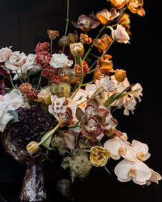 a vase filled with lots of different types of flowers