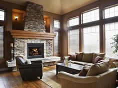 a living room filled with furniture and a fire place in the middle of a room