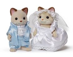 two stuffed animals dressed in wedding clothes