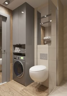 a bathroom with a washer and dryer next to each other in front of a toilet