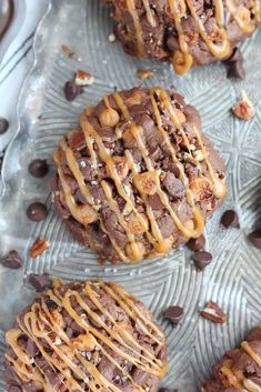 chocolate cookies with caramel drizzle and pecans on a glass platter