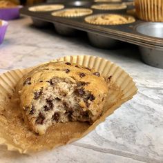 a muffin sitting on top of a paper cupcake liner