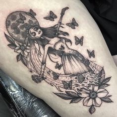 a woman is sitting on top of a bed with butterflies and flowers around her legs