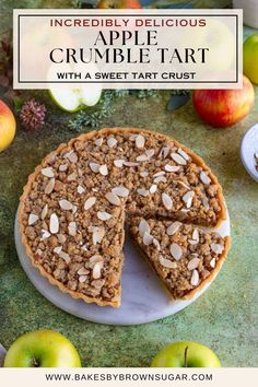 an apple crumble tart is cut into slices on a plate with apples in the background