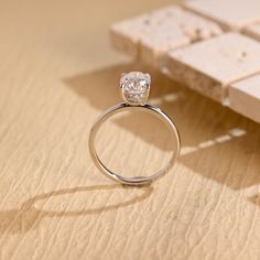 a diamond ring sitting on top of a wooden table