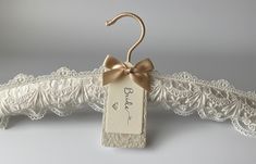 a wedding dress hanger with a bow on it's end and the tag that says, bridal