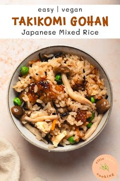 a bowl filled with rice and vegetables on top of a white table next to a napkin