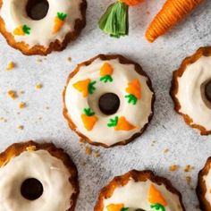 carrots with icing and black olives are arranged on a white tablecloth