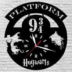 a hogwarts clock on a white brick wall