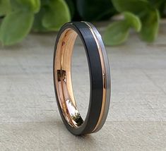 a black and gold ring with two tone inlays on the outside of it