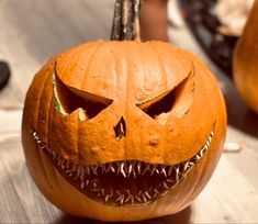 a carved pumpkin with sharp teeth on it