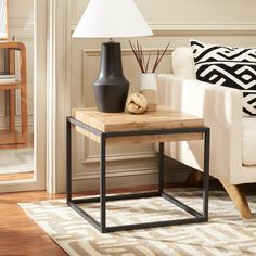 a living room scene with focus on the end table and lamp in the foreground