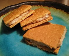 three crackers sitting on top of a pan with some food in it's middle