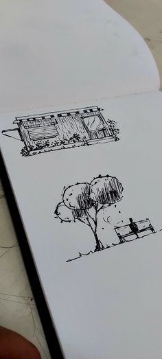 a drawing of a house and tree on a piece of paper