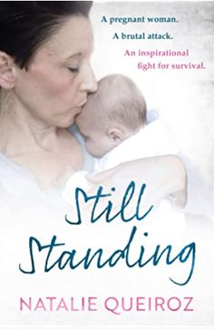 a woman holding a baby in her arms with the words still standing written on it