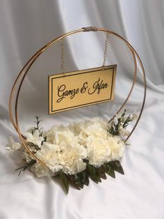 a white flower arrangement in front of a sign that says genga & afon