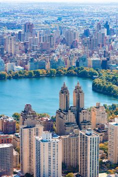 an aerial view of the city and its surrounding lake, with skyscrapers in the foreground