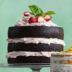 a chocolate cake with whipped cream and strawberries on top