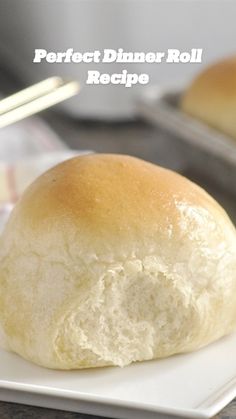 a white plate topped with a bun on top of a counter next to a pan