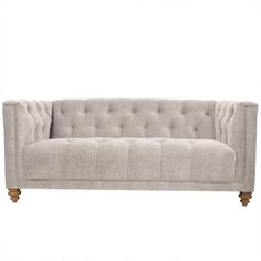 a gray couch with wooden legs and buttons on it's back end, against a white background