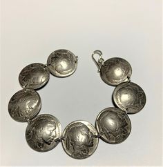 Coins - Vintage Buffalo Nickle Coin Bracelet Sterling Silver Links. Sterling silver links & clasp. Fits wrist size 7 inches. Larger sizes available. Feel free to ask for a size larger than what is listed. Classic Metal Bracelets With Sterling Silver Clasp, Antique Silver Engraved Bracelet, Vintage Sterling Silver Round Bracelet, Vintage Round Sterling Silver Bracelet, Classic Nickel-free Silver Jewelry, Classic Adjustable Nickel-free Charm Bracelet, Antique Silver Engraved Bracelets, Elegant Stamped Bracelet, Classic Collectible Nickel-free Jewelry