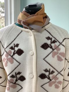 Thick Acrylic 60's -70's Sweater  Crew neck Button front with Raglan sleeves  Leafy design on front in colors of beige and dark chocolate brown  Yarn covered buttons  Boxy fit  Size 12-14 Shoulders- 16 1/2" Sleeves -23" 24" Bust -44" Waist -46" Length - 22 1/2" Beautiful vintage condition,pre owned White Retro Sweater With Buttons, Retro White Sweater With Buttons, White Fitted Retro Cardigan, Vintage Beige Button-up Sweater, Fitted Button-up Retro Cardigan, Retro Fitted Button-up Cardigan, Retro Cream Cardigan For Fall, Fitted Brown Retro Cardigan, Vintage Cream Button-up Sweater