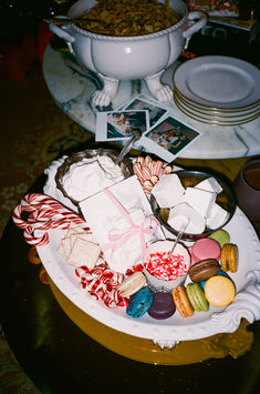 a plate full of assorted candy and candies on a table with other items