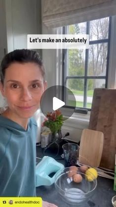 a woman standing in front of a kitchen counter with food on the counter and an image of her face