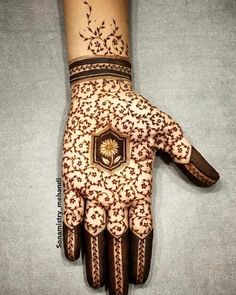 a hand with henna tattoos on it